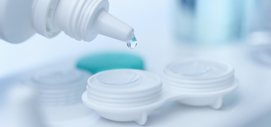 Contacts solution being dropped into a contact lens case
